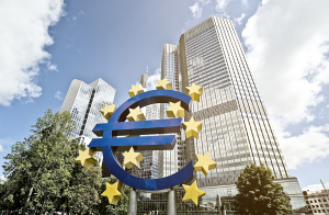 FRANKFURT AM MAIN, GERMANY -  MAY 14, 2014: Euro sign in front of the European Central Bank (Europaeische Zentral Bank) headquarter building